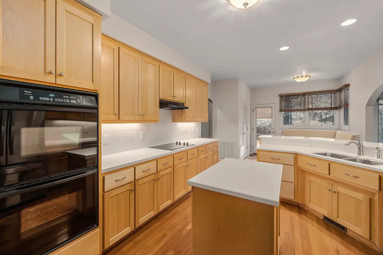 The same type of 1990s honey oak kitchen before work began (sample photo)