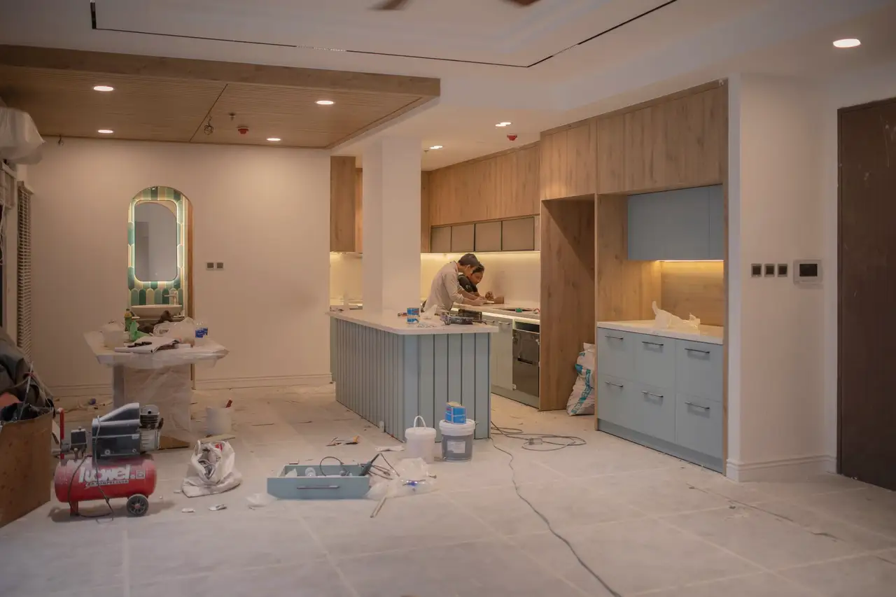 Crew installing cabinets mid-build